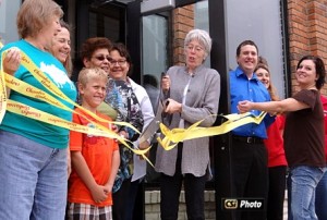 Taylor Barnes cuts the ribbon to the Arts Center