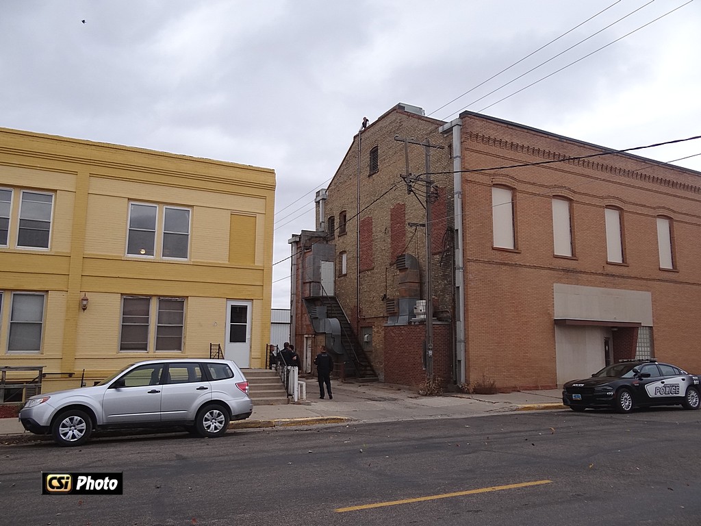 Individual can be seen on top of building near west end. 